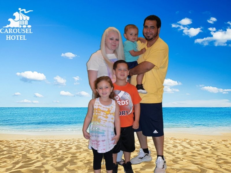 a family poses for a photo on the beach