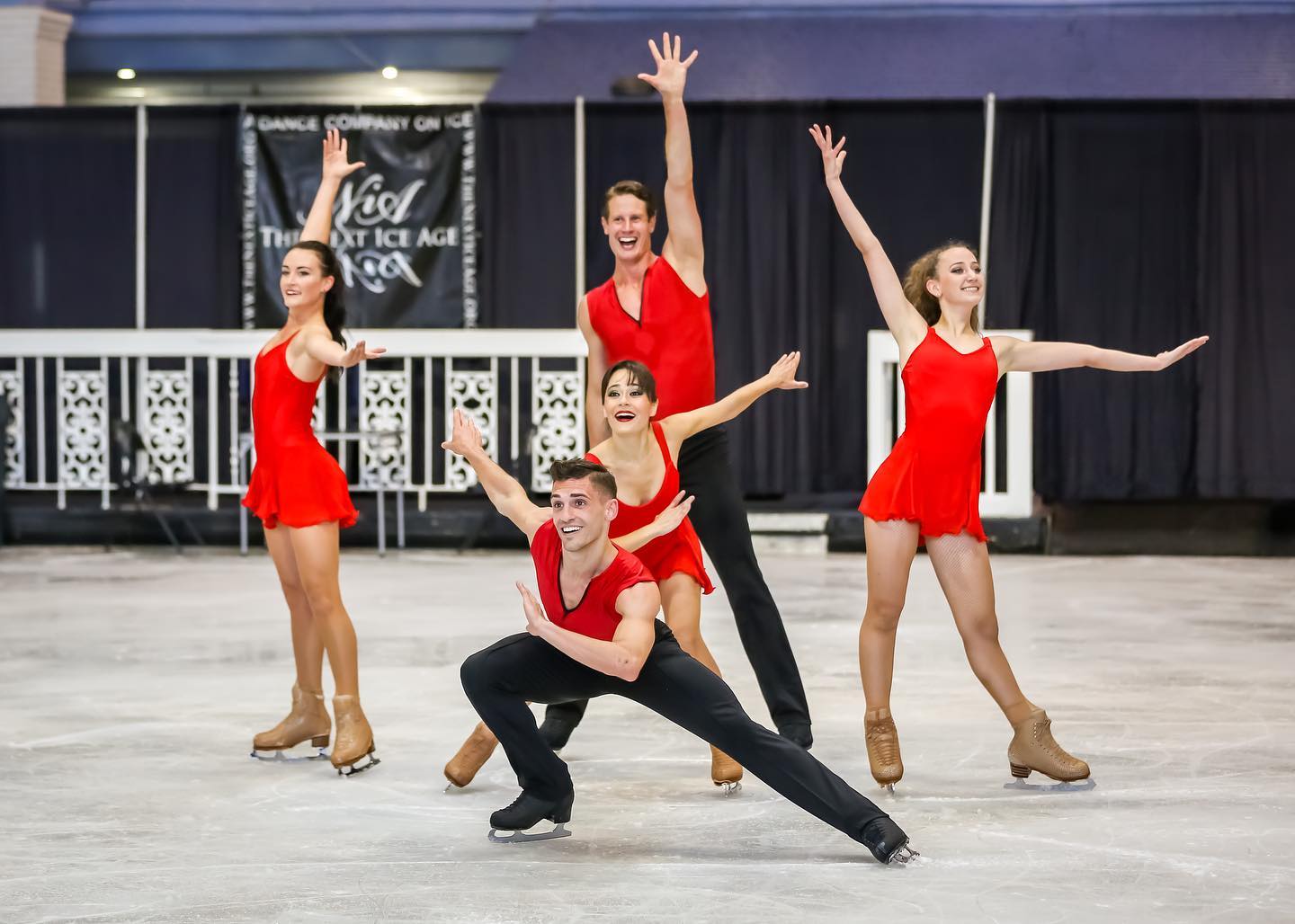 a group of young people standing on top of an ice rink