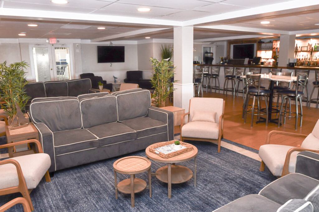 a living room filled with furniture and a bar