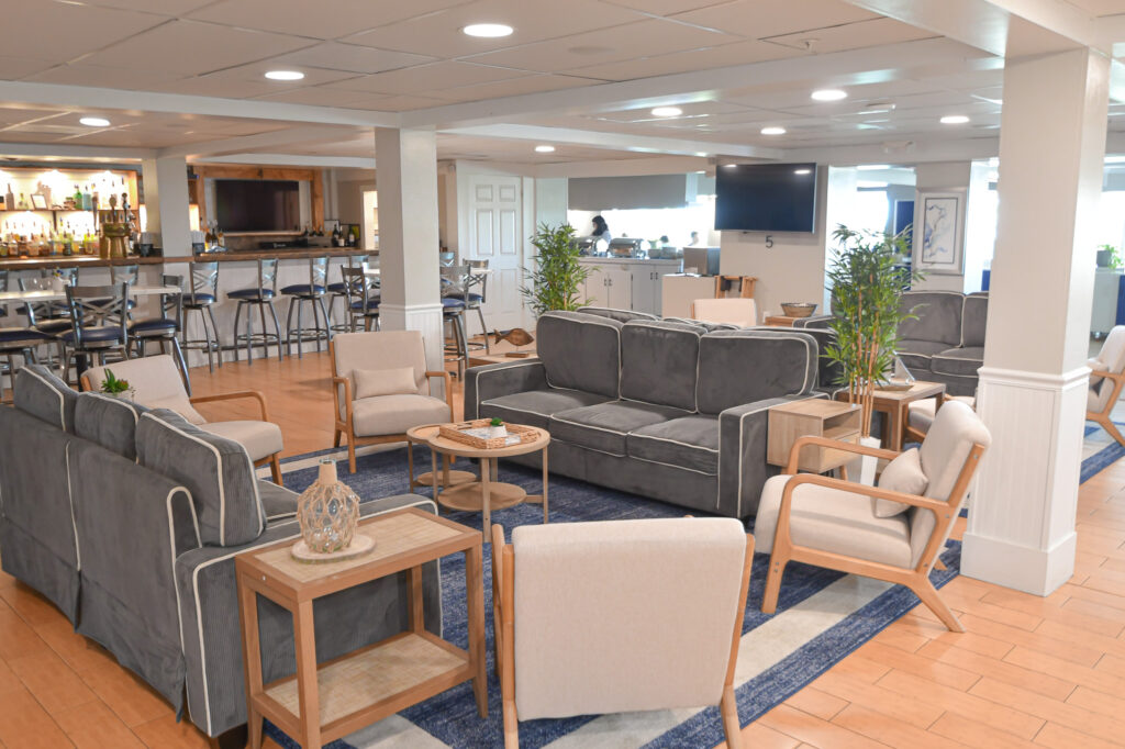 a living room filled with furniture and a bar