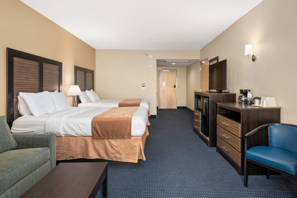 a hotel room with two beds and a couch