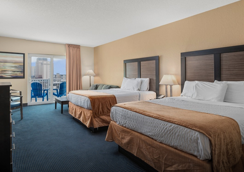 a hotel room with two beds and a television