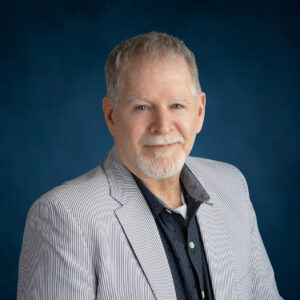 a man in a suit posing for a photo