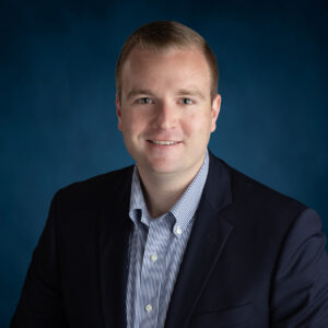 a man in a suit and tie posing for a photo