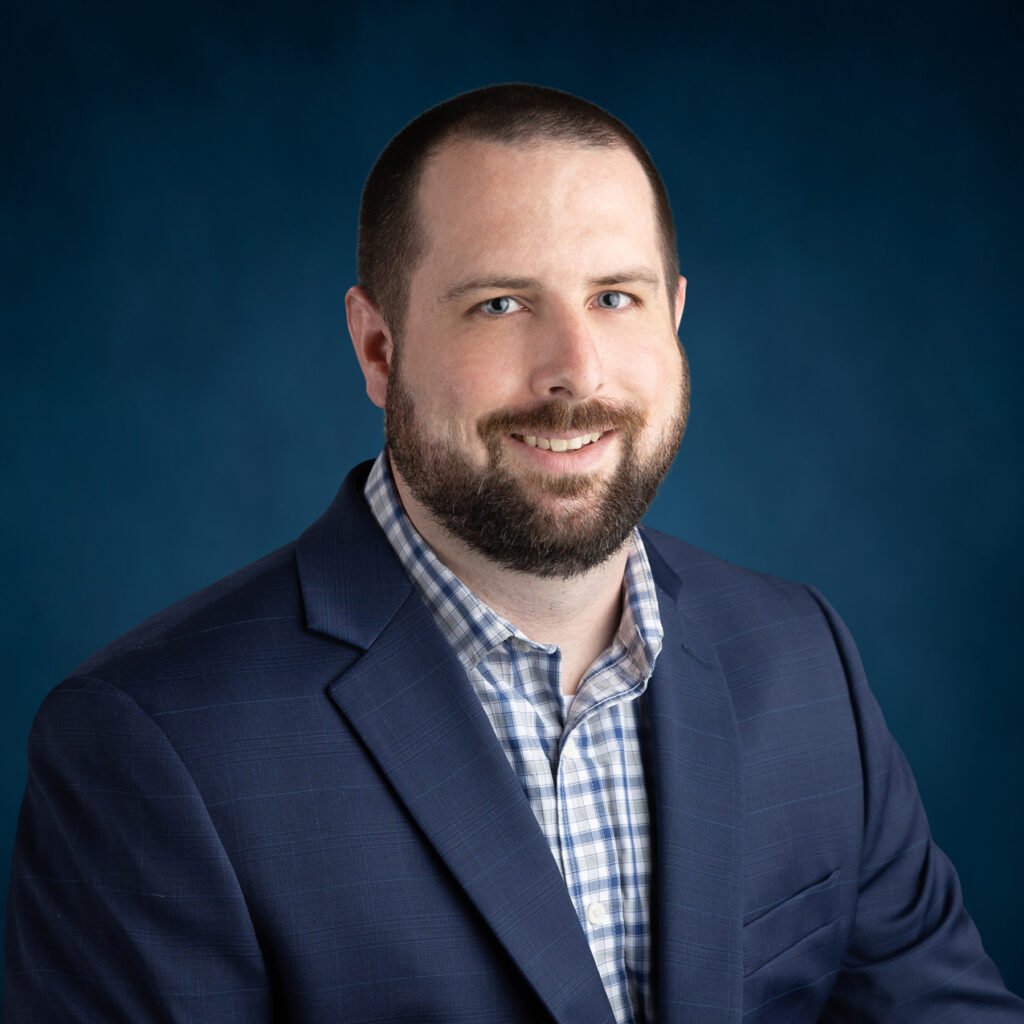 a man with a beard wearing a blue suit