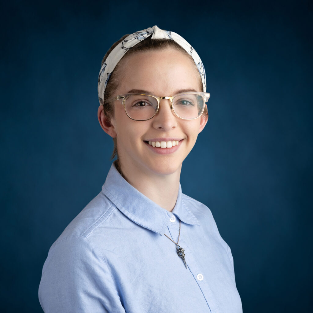 a woman wearing glasses and a head scarf