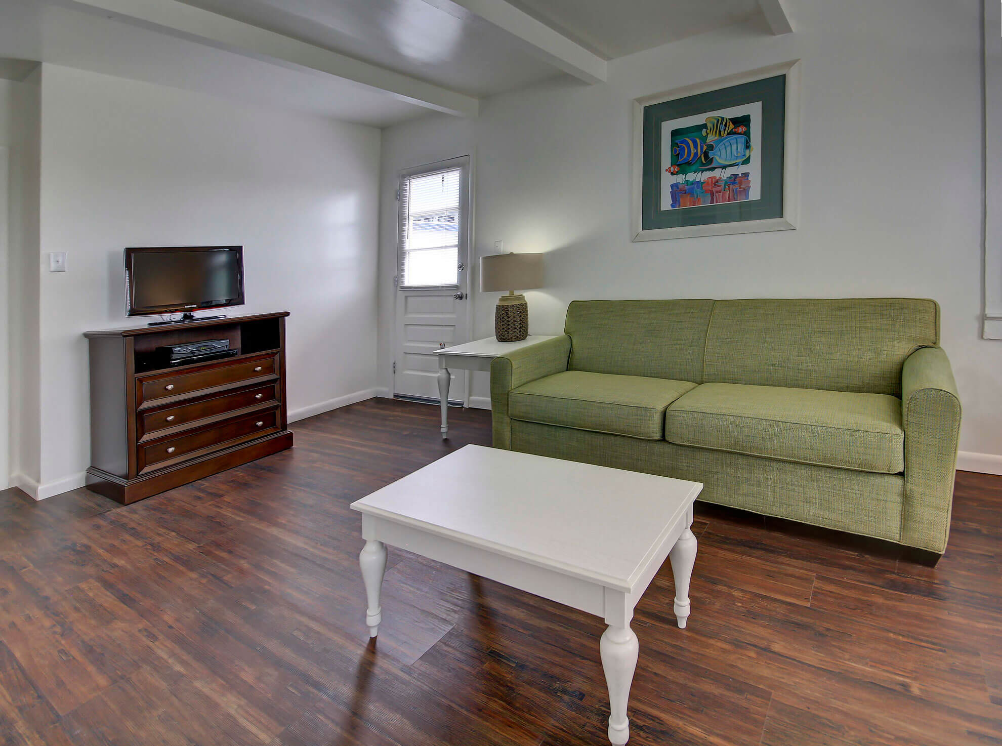 a living room filled with furniture and a flat screen tv
