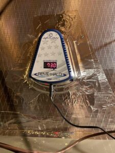 a digital thermometer sitting on top of a piece of plastic