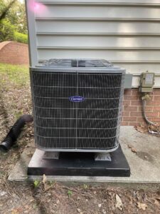 a air conditioner sitting on top of a sidewalk