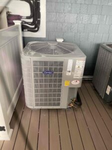 an air conditioner and a heat pump on a deck