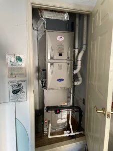 a water heater in a bathroom next to a door