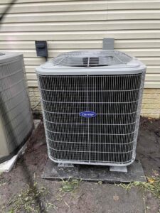 two air conditioners outside of a house