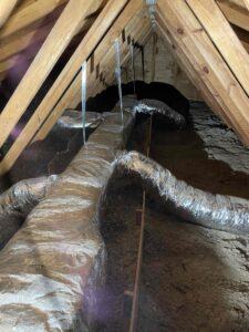 an attic with exposed pipes and exposed walls