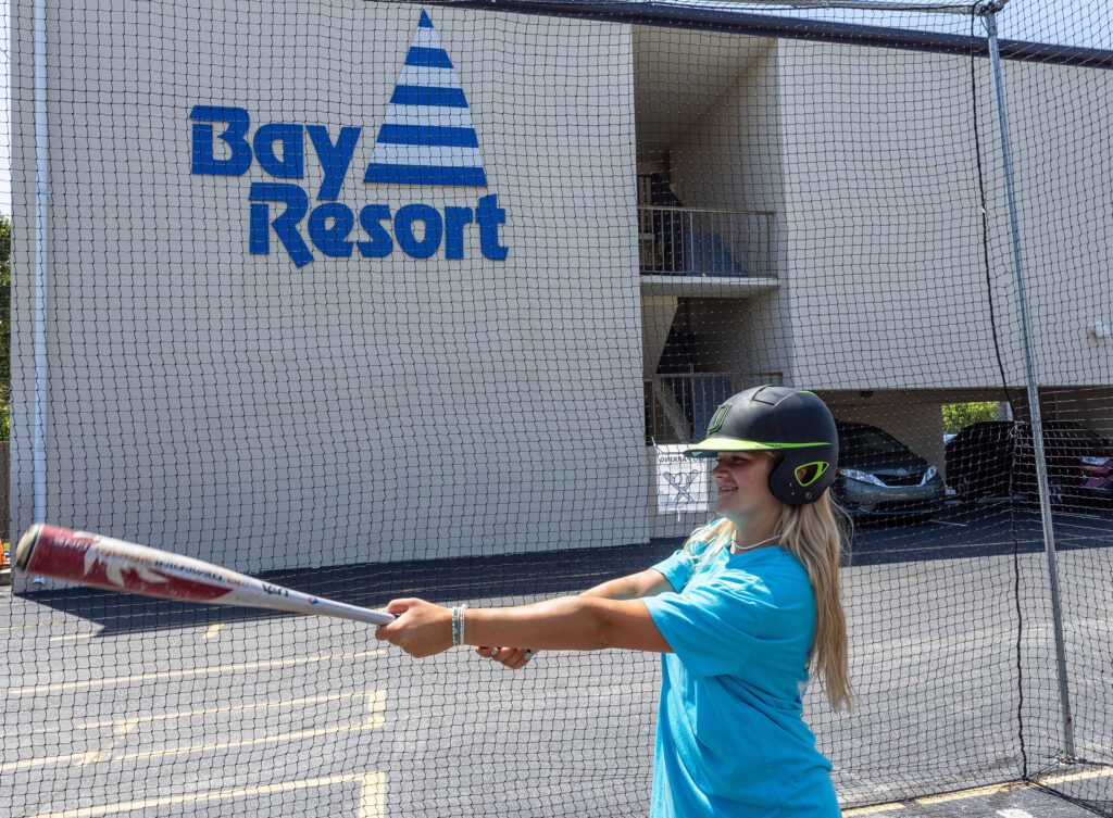 a woman is swinging a bat at a ball