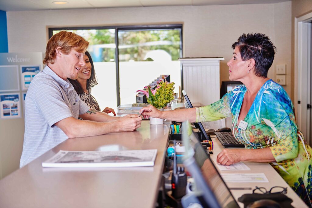 a man and a woman standing at a counter