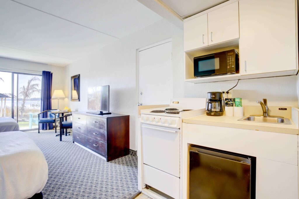 a hotel room with a bed and a kitchenette
