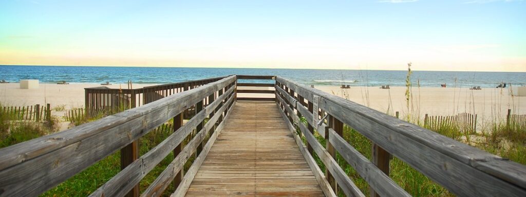 a wooden walkway leading to the beach