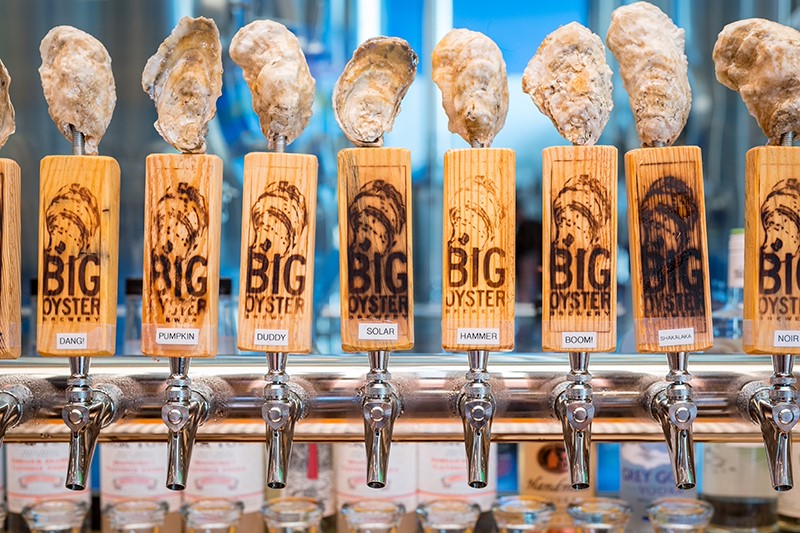 a row of beer taps filled with different types of beer