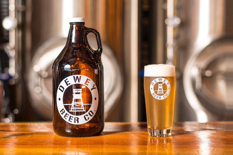 a bottle of beer next to a glass of beer