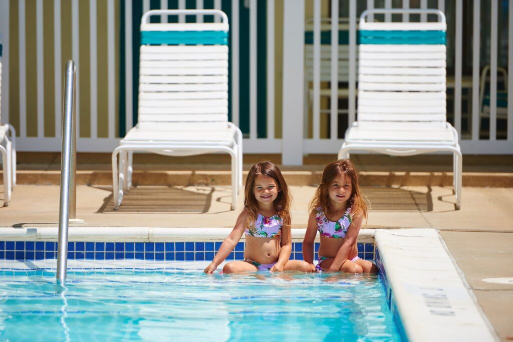 two little girls sitting in a swimming pool