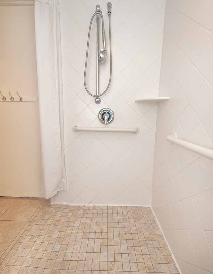 a bathroom with a tiled floor and a shower