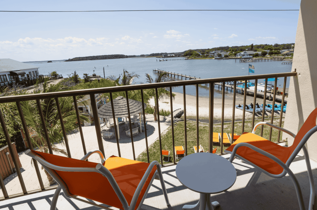 a balcony with chairs and a table on it