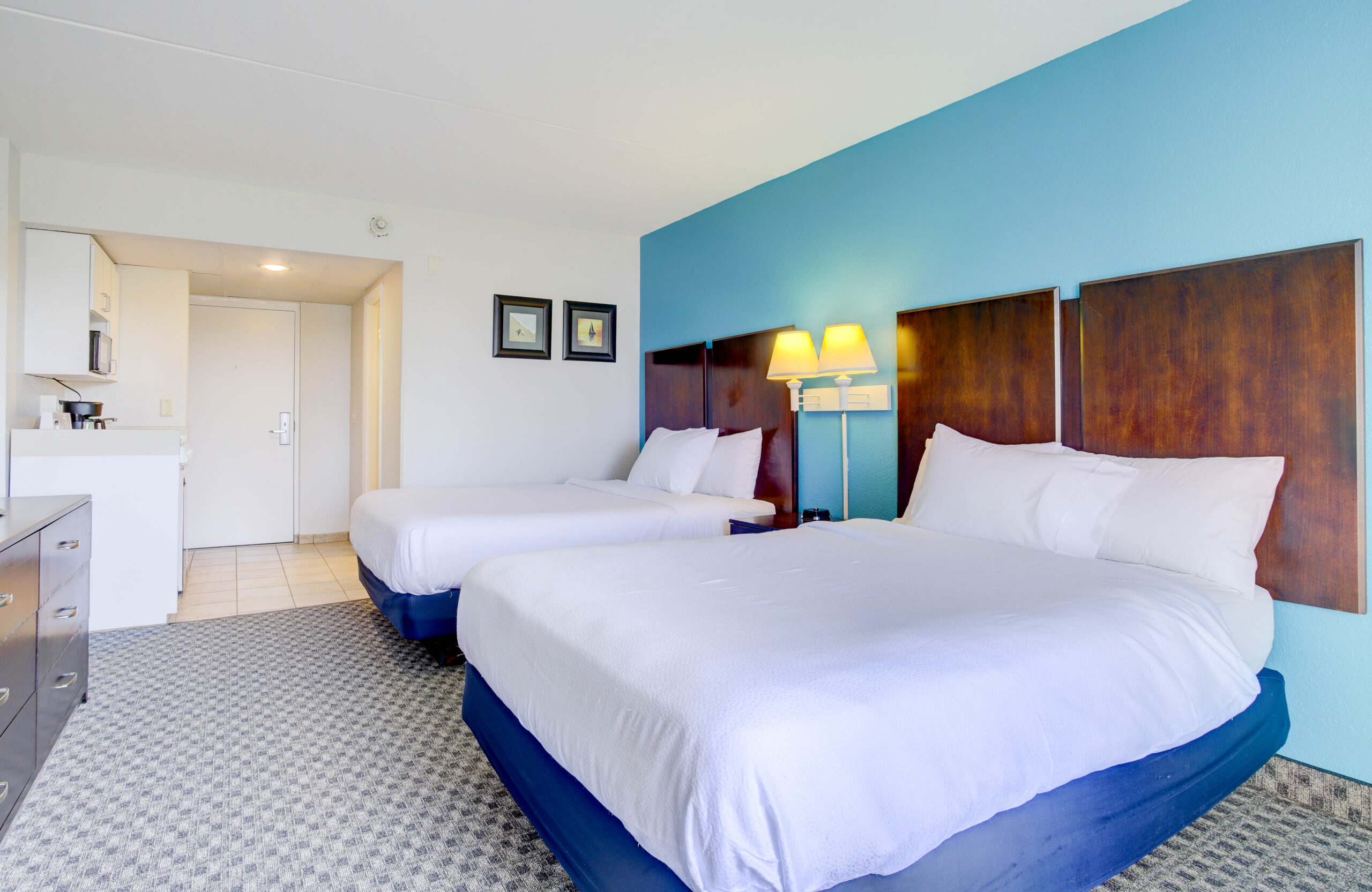 Two double beds in a hotel room.