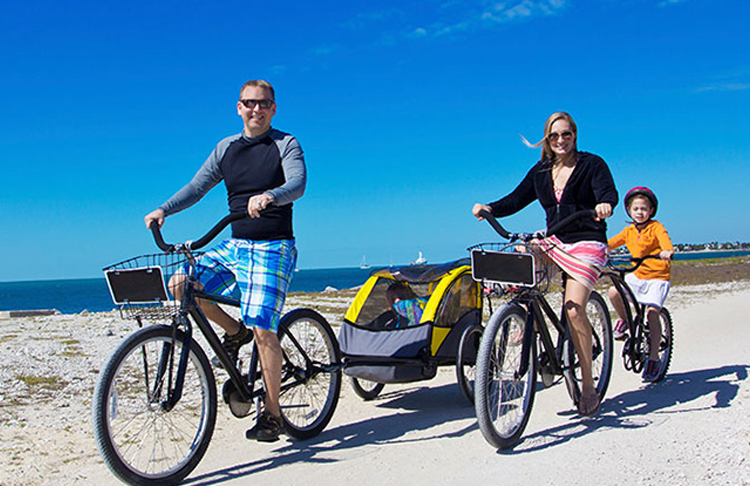 A family biking on a path near the bay