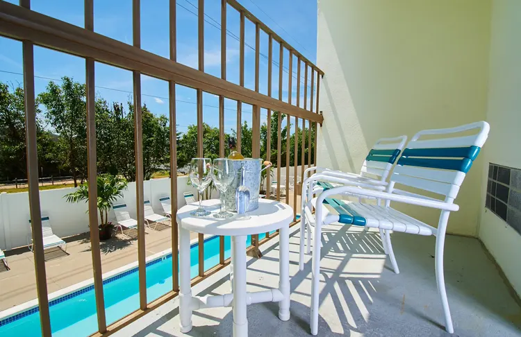 A balcony over looking a pool.