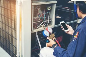 man performing air conditioning maintenance