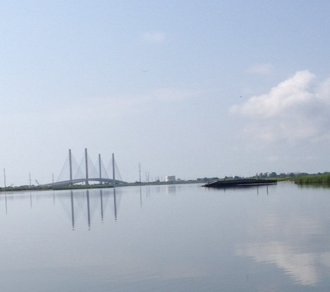 The Indian River Inlet Bridge reflecting in calm water. The Indian River Inlet Bridge reflecting in calm water.