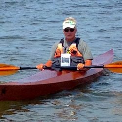 Neil testing out the kayak he built