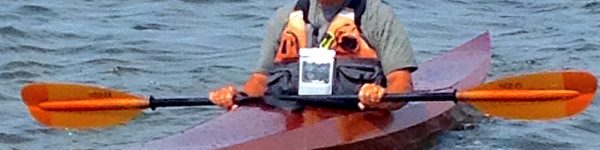 Neil testing out the kayak he built