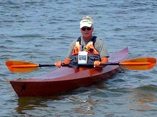 Neil testing out the kayak he built
