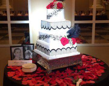 spolight illumitates multi-tiered wedding cake on table