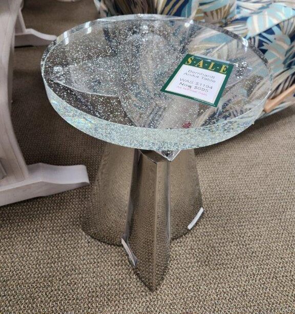 a glass table with a sign on it