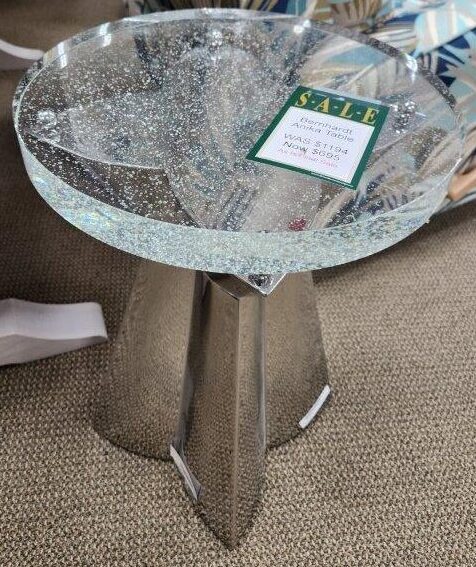 a glass table with a sign on it