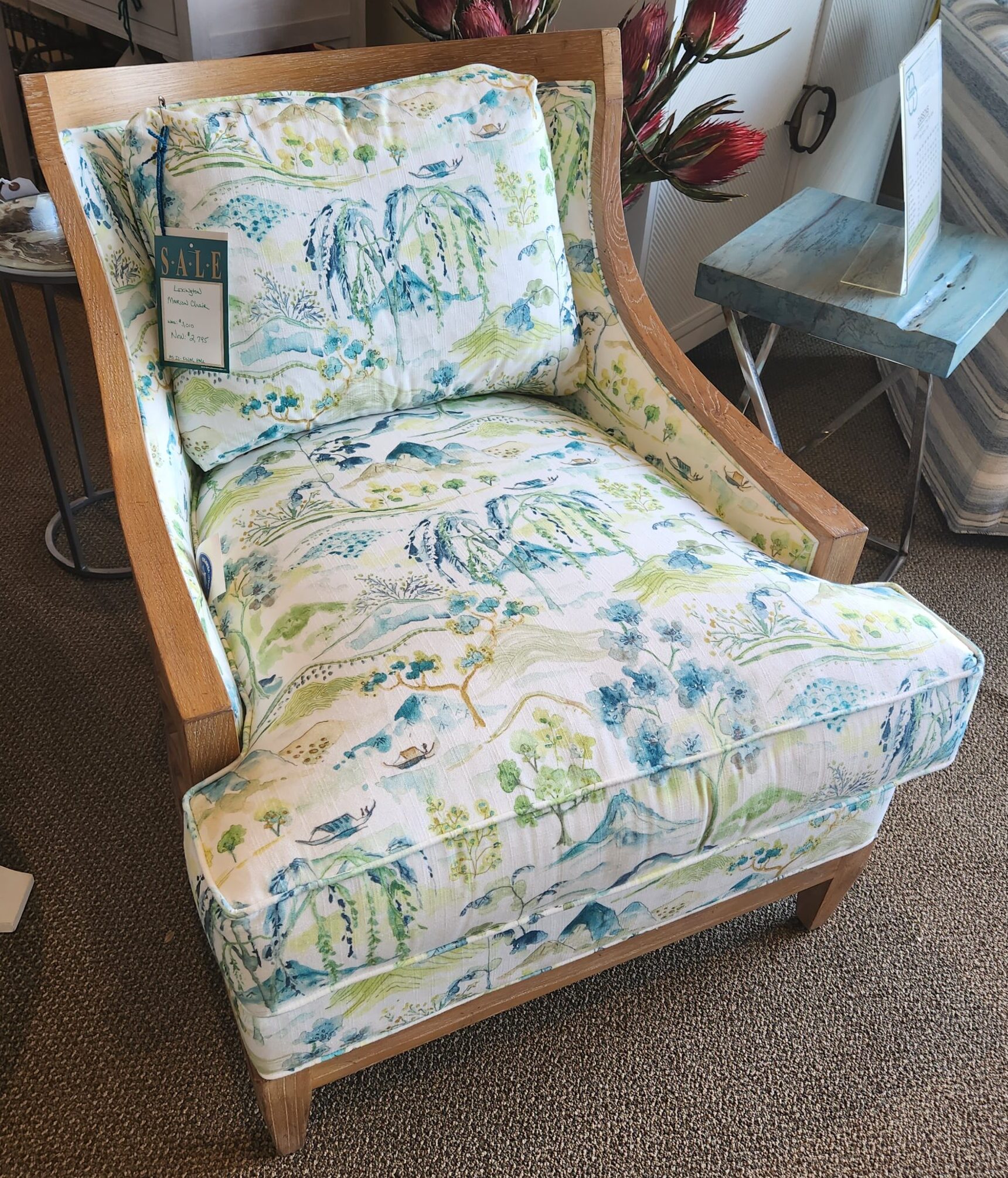 a chair with a blue and green floral pattern on it