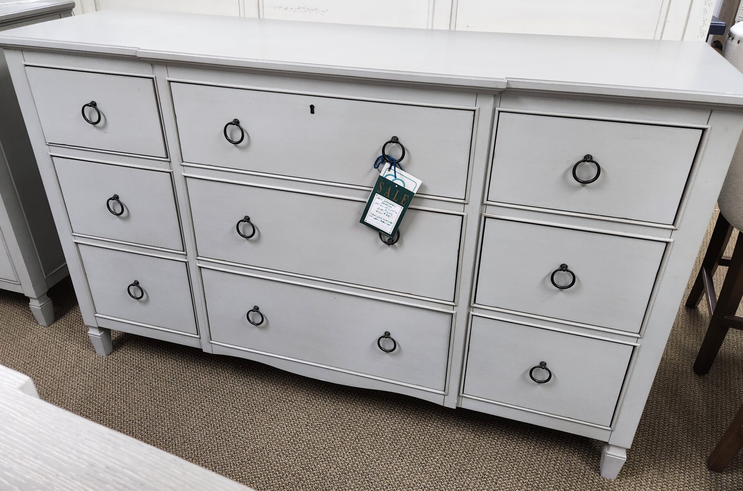 a white dresser with several drawers on top of it