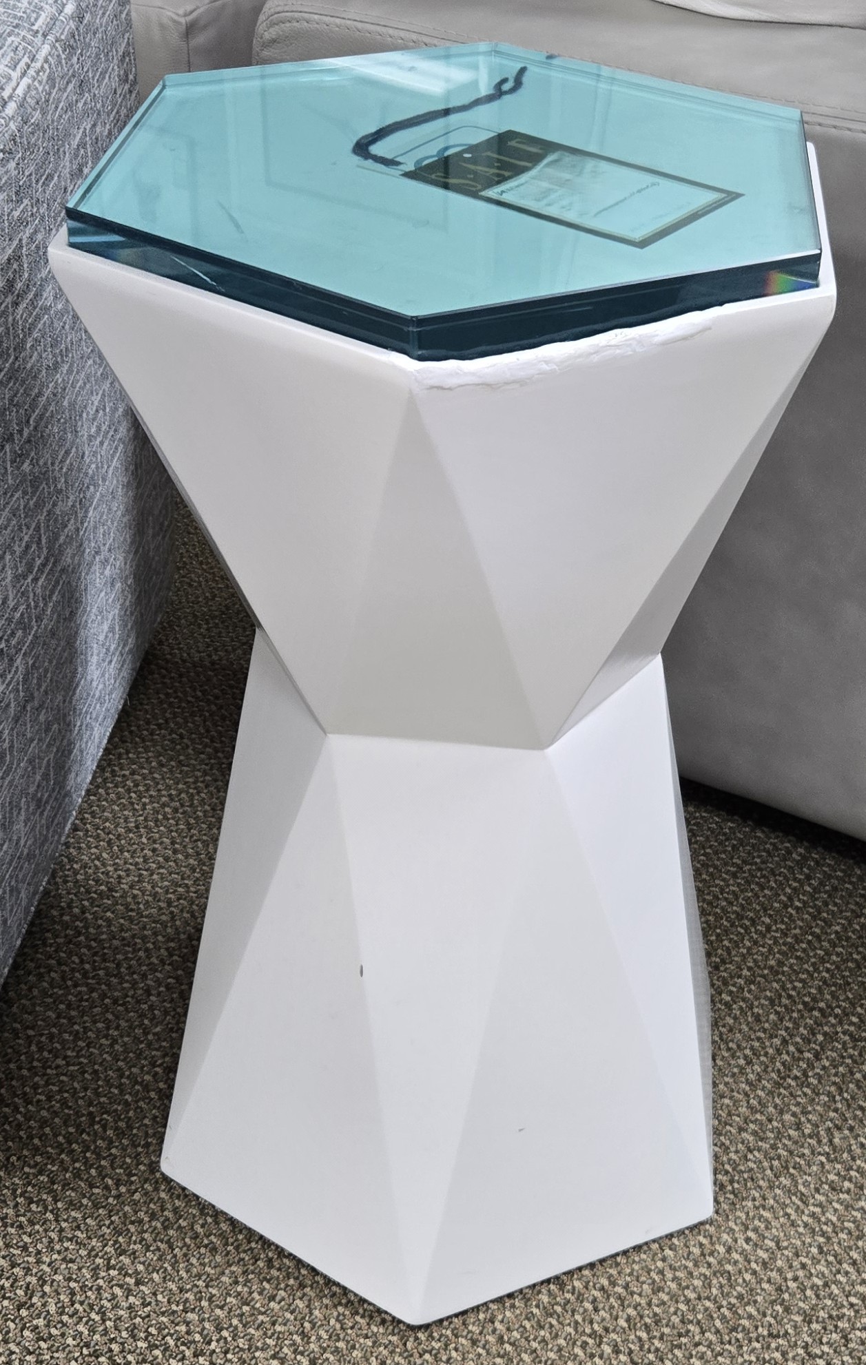 a white table with a glass top in a living room