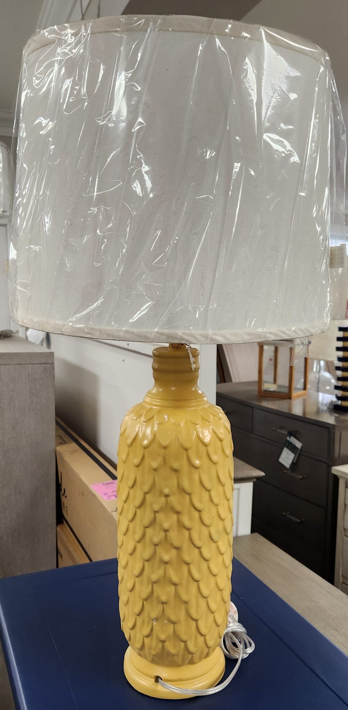 a large plastic object hanging from the side of a blue cabinet