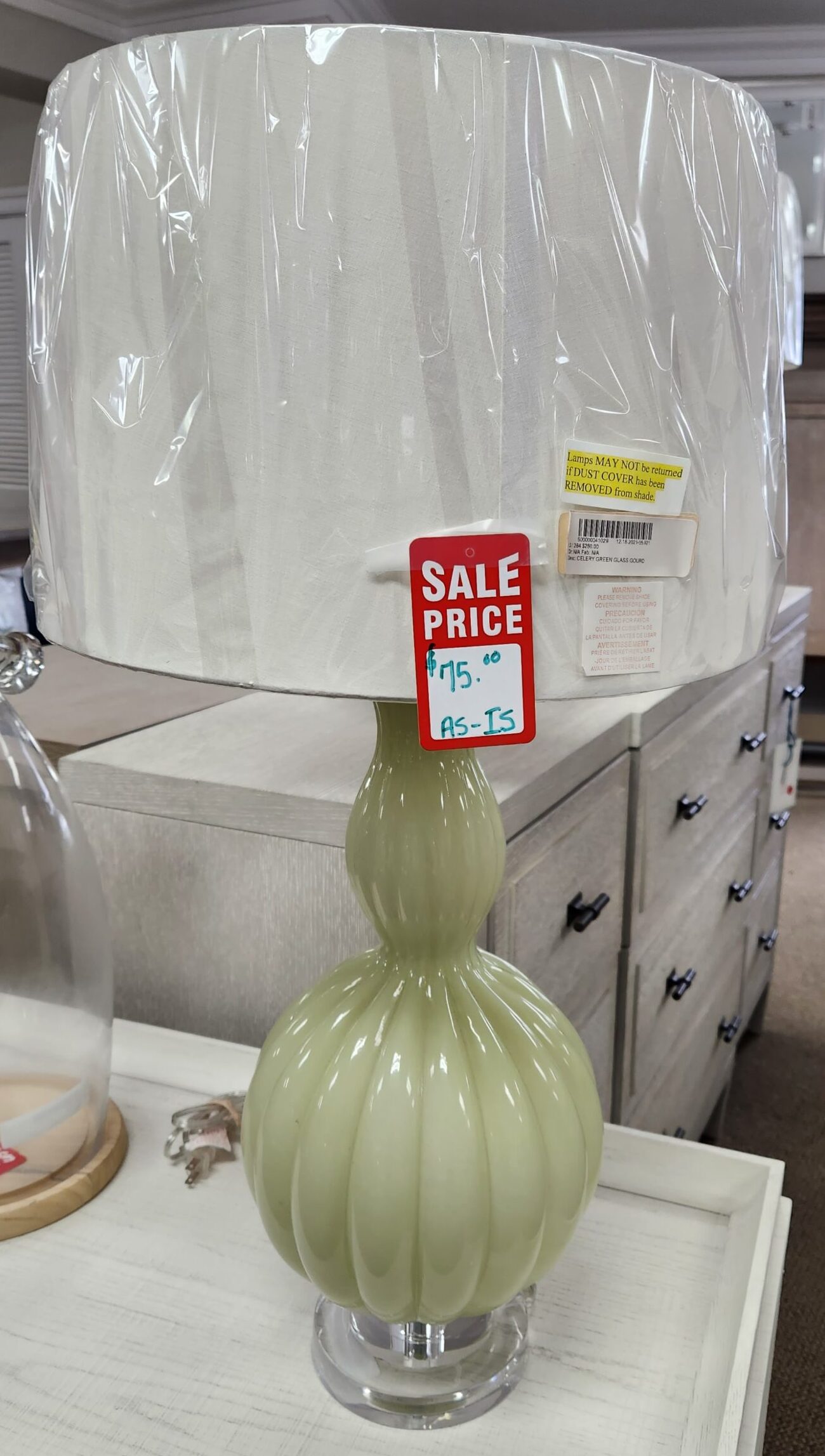 a green lamp sitting on a table