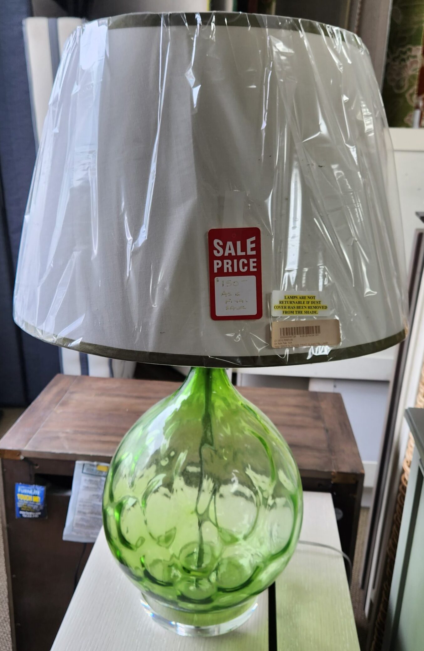 a green vase is on a table
