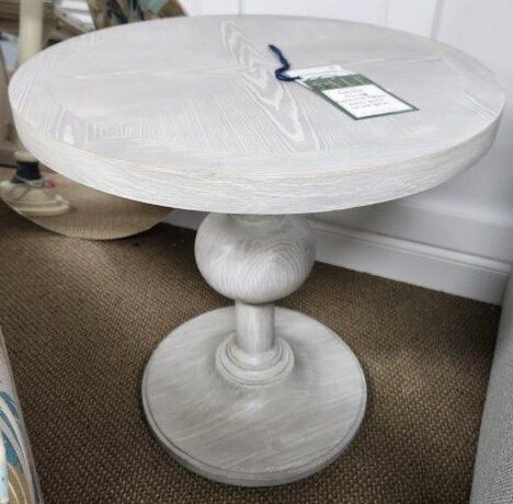 a white table sitting on top of a carpeted floor