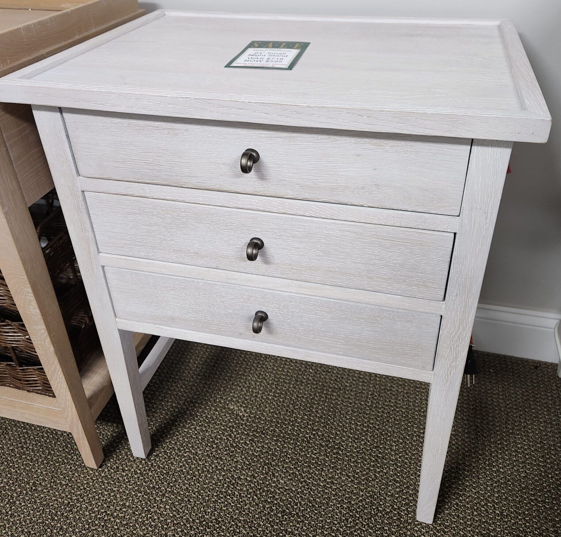 a white cabinet sitting on top of a wooden shelf