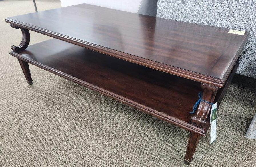 a wooden table sitting on top of a carpeted floor