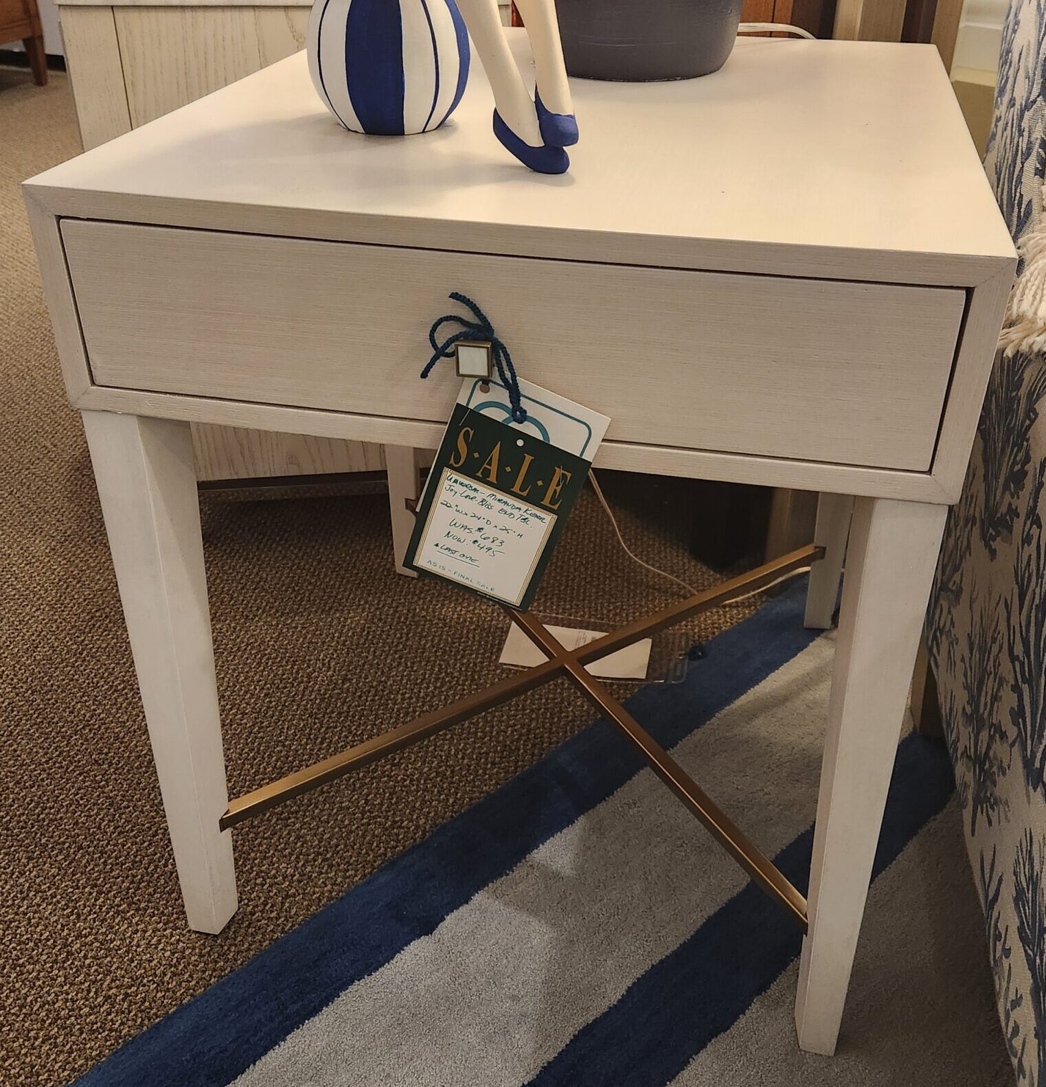a bed with a blue and white comforter on top of it