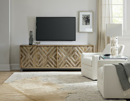 a living room with white furniture and a flat screen tv