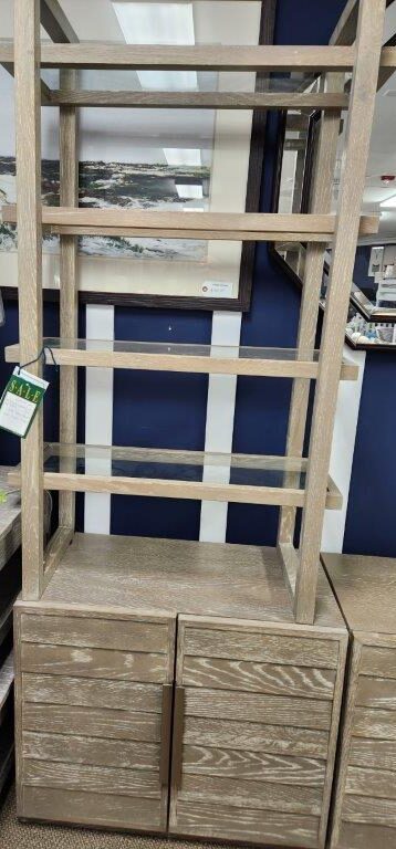 a wooden shelf with drawers and a lamp