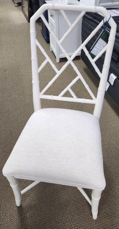 a white chair sitting in a room next to a desk